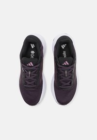 Athletic shoes in dark purple mesh with black accents, featuring a cushioned white sole, lacing system, and branded insoles.