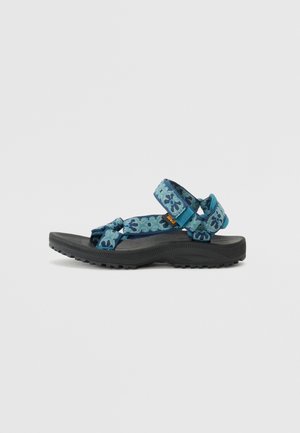Blauwe sandalen met een patroon en verstelbare banden, voorzien van een gestructureerde zwarte zool en een gevoerde binnenzool voor comfort.