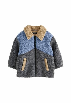 Veste en fausse fourrure avec fermeture éclair. Texturée en bleu, gris et beige. Dispose d'un col et de deux petites poches avant.
