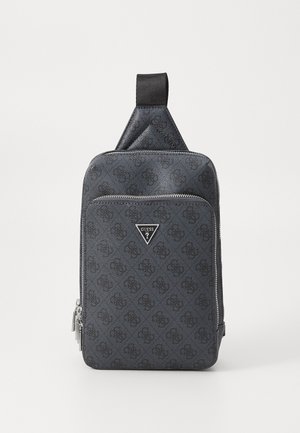 Black patterned backpack with a smooth texture, zip closure, triangular logo, and a reinforced top handle for easy carrying.