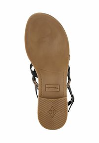 Svart sandal med flätade detaljer, tan gummisula med texturerat grepp och storlek 37-etikett på undersidan.
