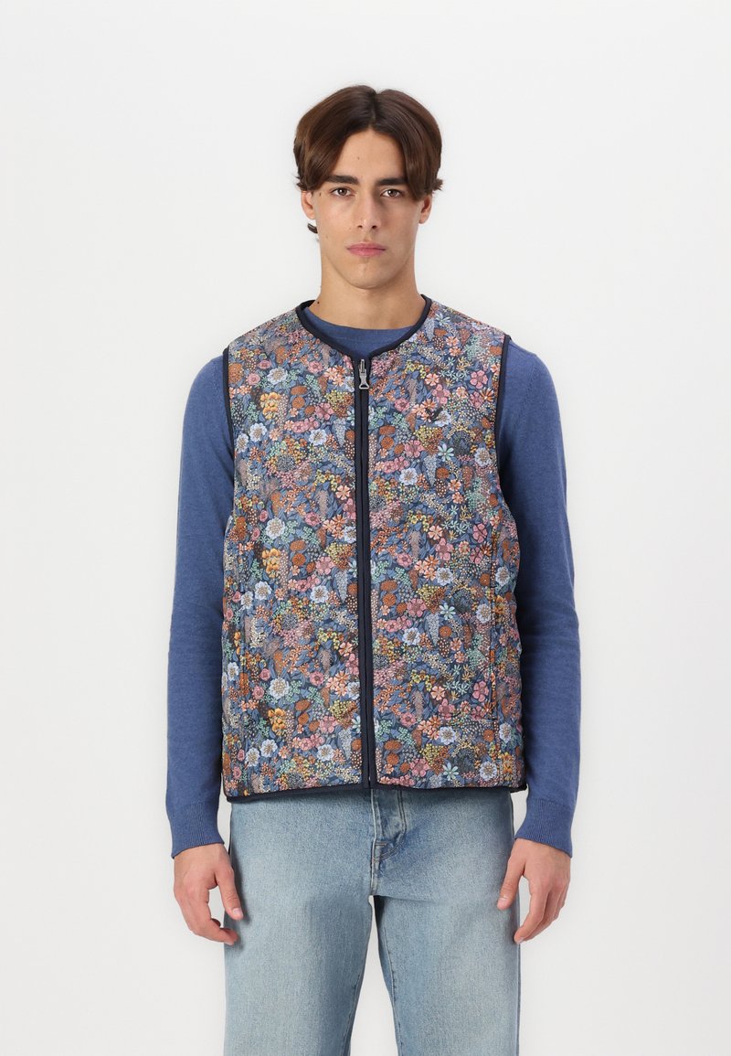 Floral-patterned vest with a zip front, featuring various shades of blue, pink, and orange flowers on a dark background. Textured fabric.