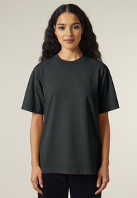 Black cotton t-shirt with short sleeves, relaxed fit, crew neckline, and smooth texture. Plain design with no visible patterns or accents.