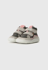 Gray and pink children's shoes with a textured upper, velcro straps, and a white rubber sole featuring a patterned tread.