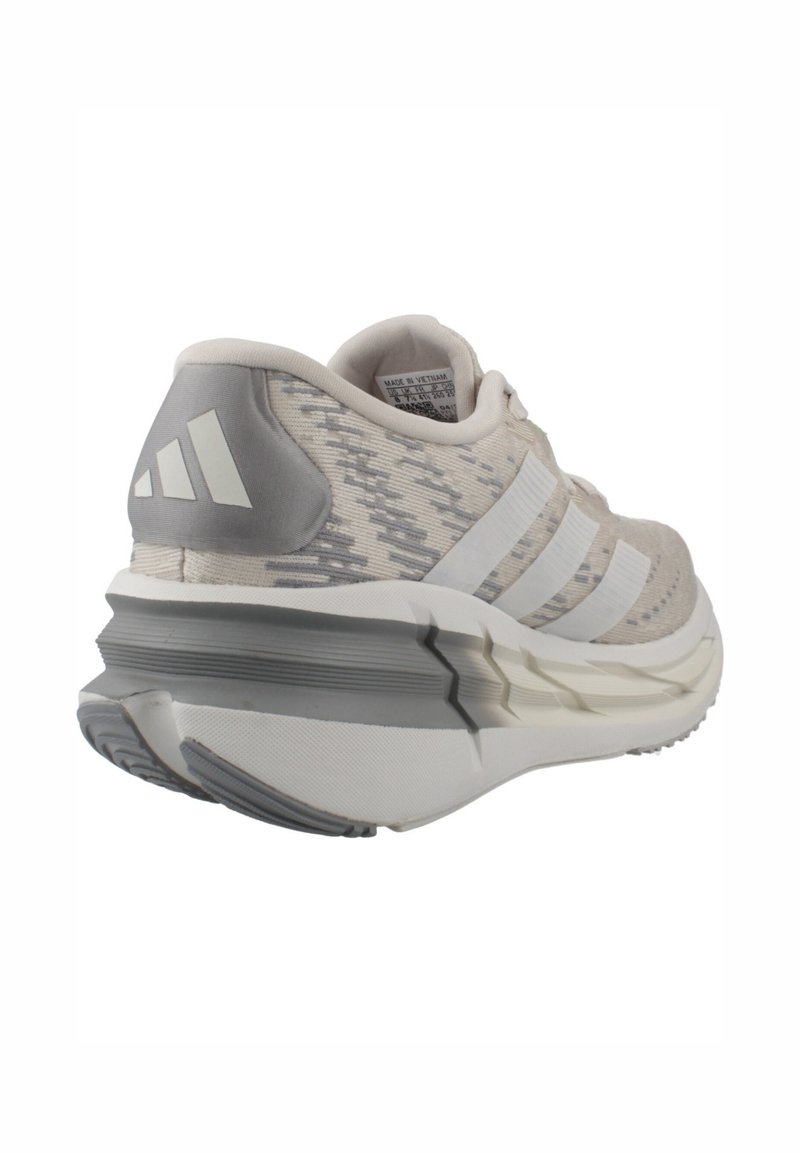 Light gray athletic shoe with white stripes, cushioned sole, and branded heel tab, angled to show rear and side details.