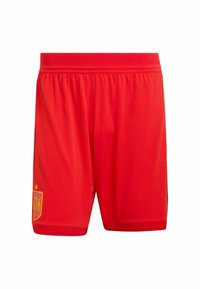 Punaiset jalkapalloshortsit, valmistettu kevyestä kankaasta. Niissä on joustava vyötärönauha ja kultainen tunnus vasemman alavarren kohdalla.