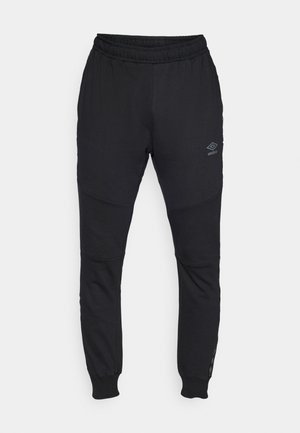 Zwarte sweatpants van zacht materiaal met een elastische tailleband, taps toelopende pijpen en een subtiel logo op de linker bovenbeen.