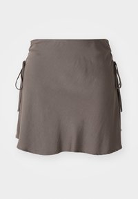 Dark brown fabric skirt with a flared design, adjustable tie sides, and a smooth texture. Hem is rounded and slightly asymmetrical.