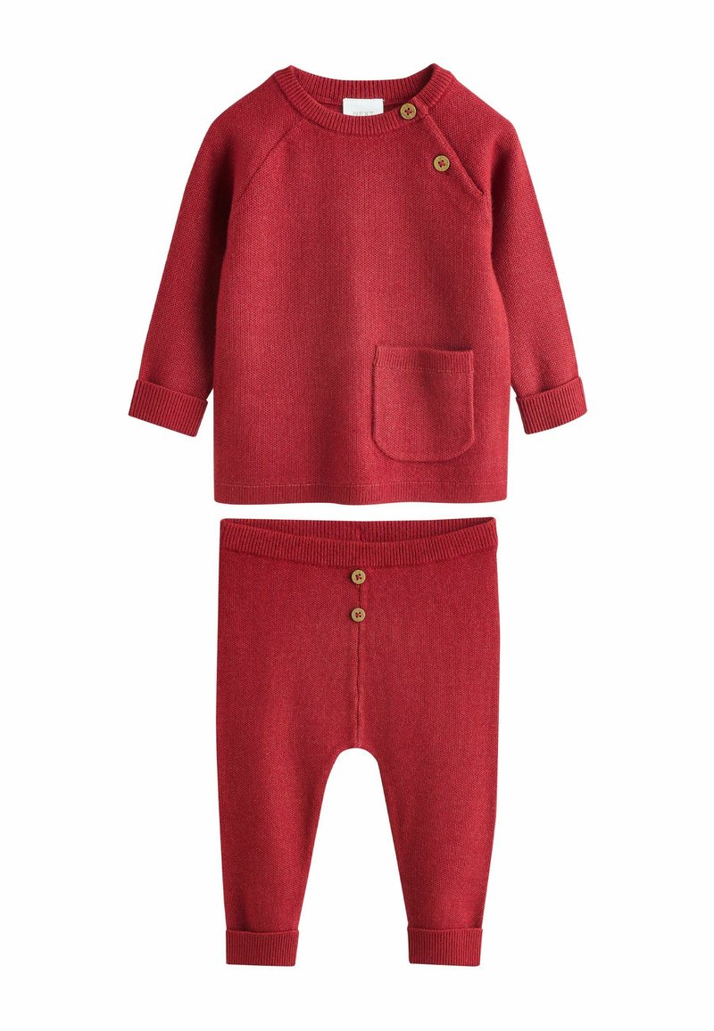 Red knit two-piece outfit featuring a long-sleeve top with a pocket and button detail, and pants with a buttoned waistband.