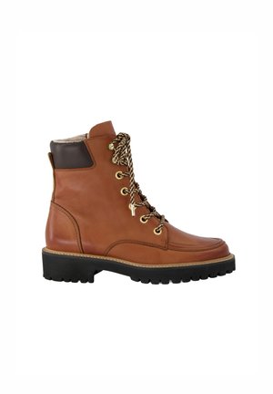 Bottes chelsea en cuir marron avec un bout arrondi, des œillets en métal et des lacets à motifs. Dotées d'une semelle en caoutchouc noir texturée et d'un col rembourré.