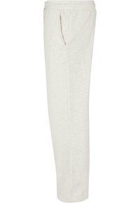 Light beige sweatpants made from soft fabric. Features two side pockets, an elastic waistband, and a straight-leg cut. Textured finish.
