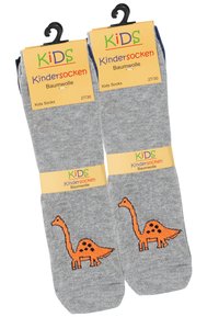 Calzini per bambini in cotone grigi con un design di un dinosauro arancione. Confezionati con etichette gialle e verdi che mostrano le informazioni sulla taglia e sul materiale.