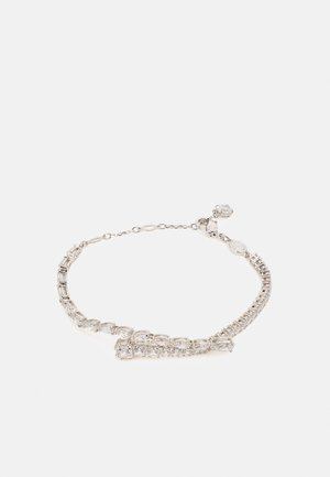 Silver bracelet featuring rectangular and round clear stones, alternating in shape. Secured with a clasp and chain extension for adjustable fit.