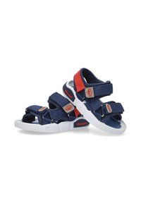 Sandalias azul marino con suelas de goma blanca, con correas ajustables, acentos rojos y una superficie texturizada para mayor agarre.