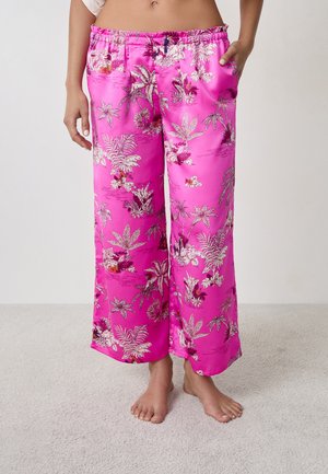 Pantalones de satén de pierna ancha en color rosa con un estampado botánico y detalles plateados. Cintura elástica y bolsillos laterales. Textura suave, estilo casual.