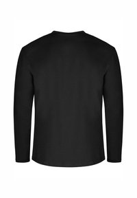 Langärmliges schwarzes Shirt aus weichem Stoff. Rundhalsausschnitt, gerade geschnitten und minimale Nahtdetails an den Ärmeln und am Saum.