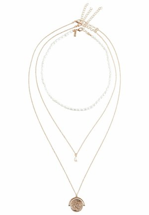 Gold-tone layered necklace featuring three strands: a pearl chain, a delicate chain, and a bottom pendant with intricate detailing.