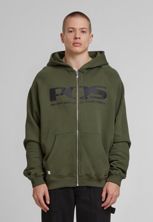 Olive green zip-up hoodie made of cotton blend, featuring a large black text logo, kangaroo pockets, and ribbed cuffs and hem.