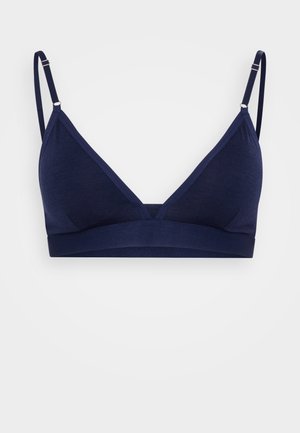 Marineblauwe draadloze bralette met een driehoekige cupvorm, verstelbare bandjes en een brede elastische band voor ondersteuning. Glad stoftextuur.