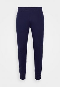 Pantalones de chándal azul marino hechos de suave algodón, con una cintura elástica y puños ajustados, y un pequeño logo en el costado.