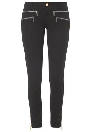 Black slim-fit pants with four horizontal silver zippers near the waist and gold zipper details at the ankle cuffs.