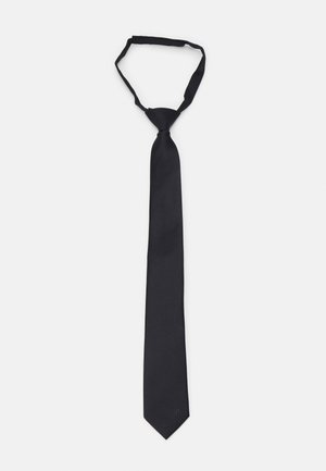 Black silk tie with a smooth texture, elongated shape, narrow width, and pointed tip; features a subtle brand logo near the tip.