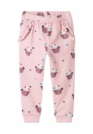 Rosa bomullssweatpants med mönster av cupcakes och hjärtan, med volangkanter på fickorna och elastiska muddar vid anklarna.