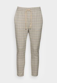 Beige plaid pants with an elastic waistband, drawstring closure, and tapered legs. The fabric features a subtle grid pattern with blue accents.