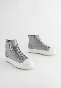 Gray high-top sneakers with a smooth textile upper, white rubber toe cap and sole, featuring double eyelets and a padded collar.