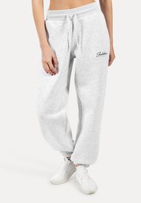 Graue Sweatpants mit lässiger Passform, elastischem Bund und gerippten Säumen. Verfügt über Seitentaschen und ein bedrucktes Logo-Detail.