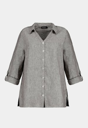 Harmaa pellavapaita V-pääntiellä, napitus ja käärittävät hihat. Sivurei'ät lisäävät mukavuutta ja liikkuvuutta rennossa leikissä.