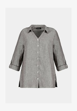 Grå linnedkjorte med V-udskæring, knaplukning og ærmer med rullegreb. Sideslidser giver lethed og bevægelse til den afslappede pasform.