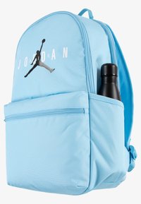 Light blue backpack made of durable fabric, featuring a front zip pocket, a black water bottle in a side pocket, and a Jordan logo.