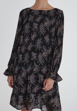 Black fabric dress with floral pattern in shades of blue, pink, and cream. Features long sleeves, pleated texture, and ruffled hem.