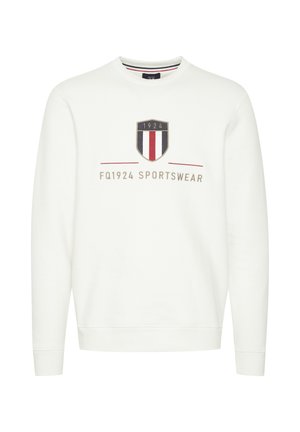 Balta džemperis, kas izgatavots no kokvilnas, ar vairoga logotipu un sarkaniem, zilajiem un krēma svītrām. Iekļautas ribotas aproces un apakšmala.