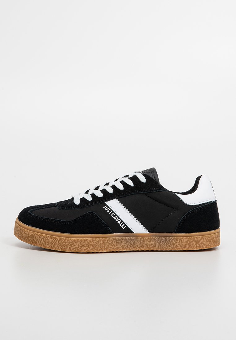Black and white sneaker with a suede and synthetic upper, flat laces, and a gum sole, featuring a logo along the side stripe.