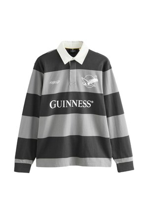Long-sleeve rugby shirt with black and gray horizontal stripes, white collar, Guinness logo, and a bird holding a pint graphic on the chest.
