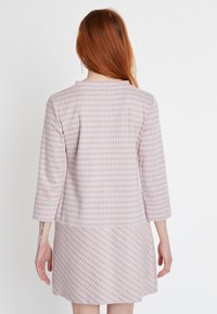 Hellpurpurnes Kleid mit einem Gingham-Muster, Dreiviertelärmeln und gerader Silhouette, das einen strukturierten Stoff zur Schau stellt.
