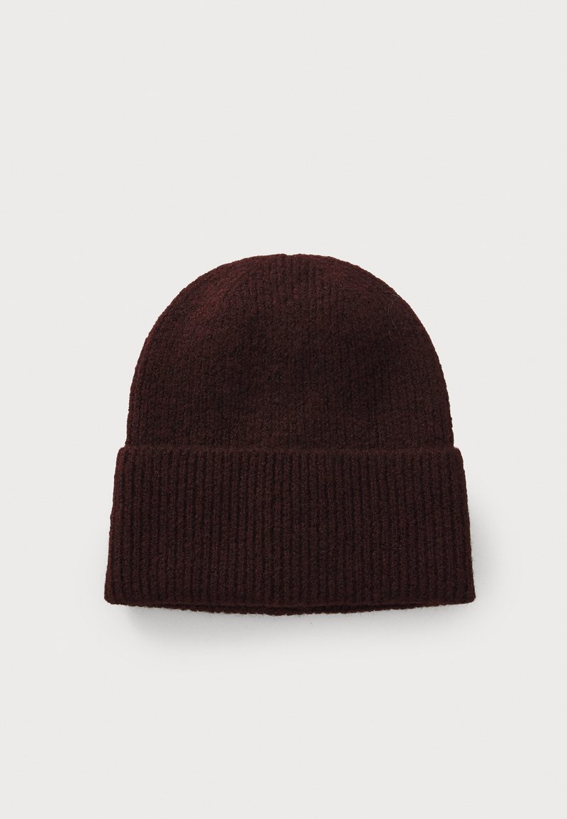 Burgundy knit beanie with a ribbed texture and folded cuff, made from a soft, warm material, ideal for cold weather.