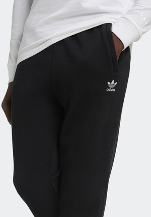 Black sweatpants made of cotton blend, featuring side pockets and an embroidered white Adidas logo on the left thigh.