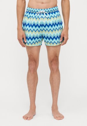 Badehose mit einem Zickzackmuster in Blau-, Grün- und Hellblau-Tönen. Hergestellt aus leichtem Material mit elastischem Bund und Kordelzug.