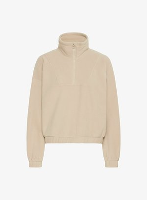 Beez värvi fliispullove kõrge kaelusega, pool-ketiga ees, soonikkoes varrukate ja vöökoht ning pehme, tekstuuriga kangas.