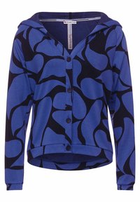 Modrá kapucínová cardigan s černým vzorem listů, předními knoflíky a dlouhými rukávy. Vyrobeno z měkkého, elastického materiálu.