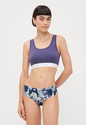 Purple cotton blend bra with a wide white band featuring "COPENHAGEN STUDIOS" and floral pattern bikini bottoms in blue, purple, and white tones.