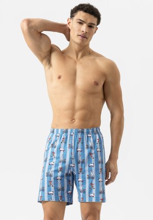 Blaue gemusterte Badeshorts mit Illustrationen von Hunden auf Fahrrädern, elastischem Bund, lockerem Schnitt und leichtem Stoff.