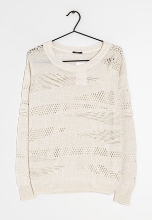 Light beige knit sweater with a relaxed fit, featuring openwork patterns, a round neckline, and ribbed cuffs and hem. Hangs on a black hook.