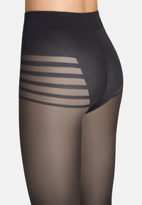 Leggings neri con vita alta, caratterizzati da pannelli trasparenti con strisce orizzontali. Il tessuto offre una texture liscia e elastica.