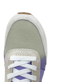 Sneaker with a light gray mesh upper, purple suede accents, and a cream suede toe box; features white laces and a brown rubber heel.