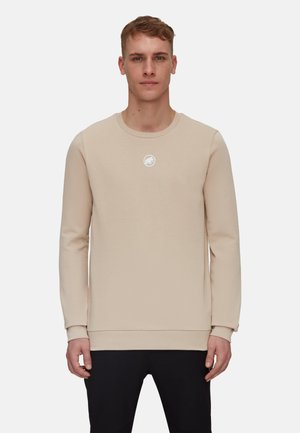 Beige sweatshirt with long sleeves and a crew neck, featuring a small white logo centered on the chest and ribbed cuffs.