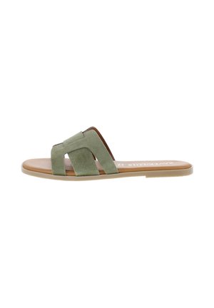 Flat sandal with light brown sole and wide olive green suede straps crossing over the foot.